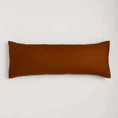 a brown pillow sitting on top of a white wall