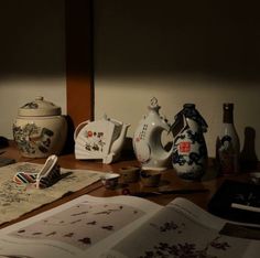 a wooden table topped with vases and other items