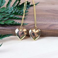 This necklace is made from a gold plated locket charm. The locket is in a shape of a simple heart and opens so you can put something special inside. The locket hangs from a gold stainless steel chain. You can choose the style and length of the chain. Please choose the length you would like the necklace in. Please choose the chain style you would like your pendant on. Please note that all necklaces are handmade and may differ from the pictured. The picture shows multiple necklaces. You will recei Gold-tone Gold Plated Locket Necklace Gift, Gold Plated Locket Necklace As A Gift, Gold Brass Heart Pendant Locket Necklace, Gold Heart Pendant Locket Necklace In Brass, Brass Heart Necklace For Anniversary, Brass Locket Necklace For Keepsake, Heart-shaped Brass Necklace For Anniversary, Gold Brass Necklace With Heart Charm, Gold Heart-shaped Brass Necklace