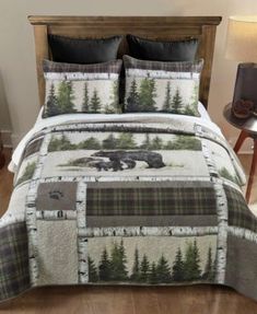 a bed with a bear and trees on it