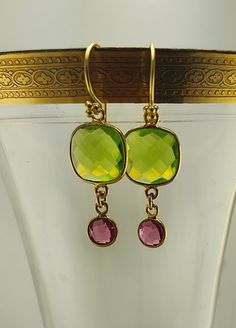 Garden Party - Faceted squares of new-leaf green peridot is handcrafted in golden vermeil (sterling silver plated with 22k gold) and adorned with rose pink tourmaline dangles. THe ear wires are also made of vermeil. Green Gemstone Dangle Earrings, Gold Peridot Jewelry With Gemstone Accents, Peridot Jewelry With Gemstone Accents In Gold, Elegant Lime Green Faceted Jewelry, Party Squares, Jupiter Fl, Leaf Green, Green Peridot, 22k Gold