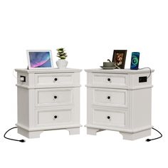 two white nightstands side by side with pictures on them