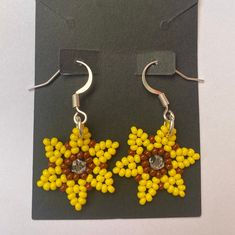 Handmade Beaded Sunflower Earrings. Hook is made of metal. Beaded Sunflower Earrings, Sunflower Beaded Earrings, Beaded Sunflower, Sunflower Earrings, Le Crochet, Bead Embroidery, Beaded Earrings, How Many, Jewelry Earrings Dangle