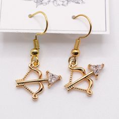 Handmade Earrings Goldtone Archers Bow And Arrow Marksman Earrings New Comes In Organza Bag Keywords: Sagittarius, Archer, Bow & Arrow, Marksmen, Present, Hanging, Earring, Drop, Birthday, Gift, Handmade, Made In Usa, Nj Artist, Female Owned, Artisan, Craft Golden Bow And Arrow, Adjustable Arrow Jewelry As Gift, Archery Necklace, Archer Necklace, Bow And Arrow Earrings, Sagittarius Earrings, Arrow Earrings, Bow Arrows, Bow Earrings