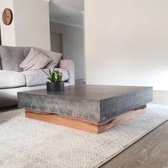 a living room with couches and a coffee table on the floor in front of it