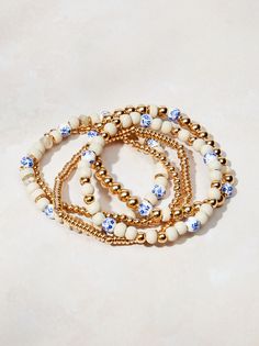 This 5-piece bracelet set lets you play with your style! Stack the two gold bangles for a simple look, or add the colorful bracelets with blue pearls and natural beads for a touch of boho flair. Mix and match for endless combinations! Bohemian Gold Pearl Bracelet With Round Beads, Bohemian Gold Pearl Bracelet With Colorful Beads, Smart Watch Bands, Beaded Bow, Blue Pearls, Boho Bangle, Preppy Jewelry, Bracelet Pack, Gold Bracelet Set