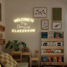 a living room filled with furniture and a neon sign on the wall above it that says welcome to my preschool classroom