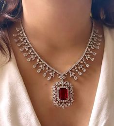 Add a touch of glamour and sophistication with this high quality red ruby pendant necklace set in beautiful zirconia stones. The stones in this set bling and look close to the real thing. This set is sure to make heads turn!  It features an adjustable necklace and a pair of earrings. It can be paired perfectly with both ethnic and western outfits.  Gorgeous fine quality Emerald CZ lab diamonds studded pendant set  in White gold plating and matching Earrings  *Comes with Statement matching earrin Luxury Traditional Necklaces For Marriage, Luxury Rose Cut Diamond Jewelry Sets For Wedding, Luxury Traditional Necklace For Marriage, Luxury Oxidized Jewelry For Engagement, Luxury Fusion Style Ruby Necklace, Luxury Multi-stone Necklace For Wedding, Luxury Engagement Necklaces For Valentine's Day, Luxury Bollywood American Diamond Danglers, Luxury Ruby Temple Necklace For Festive Occasions