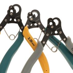 four pairs of scissors are shown in different colors and sizes, with the handles open