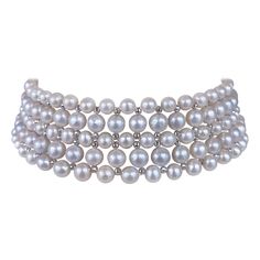 This beautiful choker features high luster White Pearls which display a wonderful sheen, all woven together into a beautiful design. Faceted, White Gold Plated Silver beads are woven between Pearls, adorning this necklace with a great and dramatic Shine when hit with light. This Choker is woven with a slight graduation to curve naturally with the neck, allowing it to be worn comfortably and snug. Measuring 13.25 inches long, this piece meets at a Decorative White Gold Plated - Silver Sliding Clasp, which perfectly matches the shine and polish of the beads. Woven Choker, Beautiful Chokers, Akoya Pearls, Elizabeth Taylor, Pearl Choker, Gold Plated Silver, Faceted Bead, Silver Beads, Pearl Jewelry