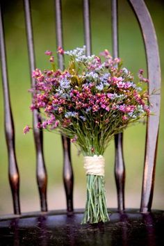 a bunch of flowers sitting on top of a wooden chair