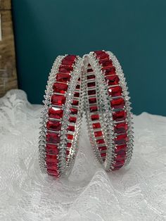 American diamond bangle/bracelet in Silver . About one inch wide. Colored stone work Crystal Bangle Bracelets As Gift, Red Round Bracelets With Diamond Accents, Stackable Diamond Cuff Bracelet Bangle, Stackable Diamond Cuff Bangle Bracelet, Red Bracelets With Diamond Accents, Crystal Bangle Jewelry As Gift, Stone Bangle Jewelry For Parties, Crystal Bangle Jewelry Gift, Party Bangle Jewelry With Stones