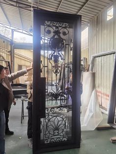 a group of people standing around a tall metal clock