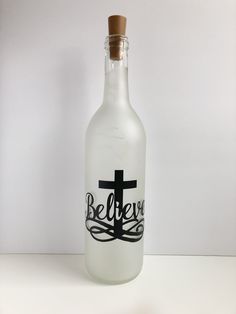 a bottle with a cross on it sitting on a table