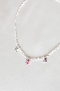 "A dainty personalized necklace featuring a colorful butterfly charm in between two crystal initials. Choose from peachy pink, turquoise blue, fuchsia pink, yellow, lavender, white, emerald green, ruby red, royal blue, jet black, and charcoal. Matching earrings: https://www.etsy.com/listing/693774042/colored-mariposa-butterfly-earrings-18k ✧ 1 gold plated necklace ✧ chain: 4mm curb (picture 2 & 5) or 3mm rolo (picture 1 & 4) ✧ lobster clasp closure ✧ nickel + lead free ✧ length: 16\"/40. Mariposa Butterfly, Delicate Choker, Turquoise Rose, Colorful Butterfly, Bleu Turquoise, Gold Initial, Custom Initials, Valentine's Gift, Butterfly Charm