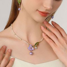 Elevate your style with our Iris Flower Pearl Necklace. The fabulous iris flower pendant, delicate enamel finish, and shinning gemstones add glamour to any outfit. The iris, with its vibrant colors and graceful sway, is a messenger of love and longing, resembling freedom, wisdom, glory, and romance. In Greek mythology, it is the rainbow goddess, and a symbol of royal power in France. A pearl chain with gentle natural allure complements the sophisticated design, making it a dreamy addition to you Elegant Enamel Flower Shaped Jewelry, Elegant Enamel Wedding Necklaces, Elegant Enamel Flower Pendant Jewelry, Floral Enamel Wedding Jewelry, Elegant Enamel Jewelry With Gemstone, Flower-shaped Enamel Jewelry For Wedding, Flower Shaped Enamel Jewelry For Wedding, Enamel Flower-shaped Jewelry For Wedding, Flower Shaped Enamel Wedding Jewelry