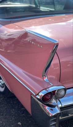 an old pink car parked in a parking lot with its hood up and the word la jolla written on it