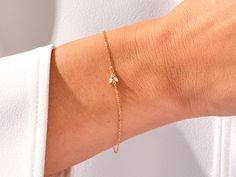 A luxurious addition to any ensemble, this Diamond Bee Bracelet in 14k Gold exudes glamour and sophistication. Featuring a 14k Gold setting and a shimmering Diamond Bee charm, this is the perfect piece for those with a taste for high-end fashion. Features• Made to Order• Gold Kt: 14K• Gold Color: Rose Gold, Yellow Gold, White Gold• Gem Stone: Natural White Diamonds• Diamond Cut: Marquise• Number of Stones: 2• Available Stone Sizes: 2 x 1.50 x 3.00 mm• Total CTW: 0.05 ct• Diamond Color - Clarity: Bee Bracelet, Bee Charms, Gem Stone, Diamond Color, Diamond Bracelets, Gold Set, High End Fashion, White Diamonds, Gold Yellow