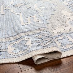 a blue and white rug is laying on the floor