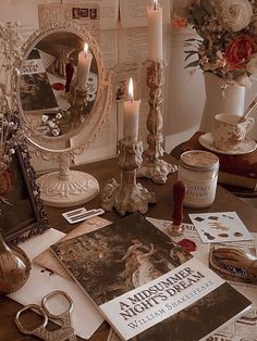 a table topped with magazines and candles