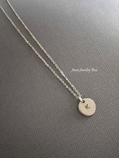 Simple disc necklace with initial. Hand stamped initial charm is on an 18'' stainless steel chain with lobster clasp. *10mm stainless steel disc *Stainless steel chain *Handmade with love <3 Like Jmesjewelrybox on Facebook for updates on new jewelry, upcoming sales and giveaways! Plus Facebook fans save 5% :D Find the coupon code on Jmesjewelrybox's cover photo https://www.facebook.com/Jmesjewelrybox Minimalist Hand Stamped Initial Necklace, Silver Minimalist Personalized Initial Necklace, Minimalist Hand Stamped Initial Necklace For Everyday, Silver Minimalist Initial Necklace, Minimalist Silver Initial Necklace, Minimalist Everyday Hand Stamped Initial Necklace, Simple Tiny Initial Pendant Charm Necklaces, Simple Tiny Initial Pendant Charm Necklace, Minimalist Round Disc Initial Necklace For Gift