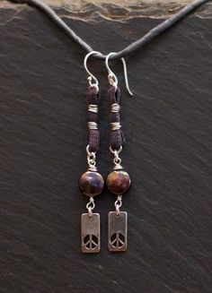 handmade/unique/one of a kind/ one world jewelry/ more than skin deep/ more than us/ pay it forward/ givingthroughjewelry/ empathic warrior/ GIVINGTHROUGHJEWELRY Peace, solitude, serenity. These handcrafted earrings are of sterling silver,  fresh water pearls and earth conscious hand dyed cotton fiber.  The color of purple smoke and incense. Wind chimes on your ears. These measure 2.75 in.,(7cm.) in total length. 10% of this sale will go to buyer's choice of charity. Please leave choice in note Artisan Oxidized Adjustable Jewelry, Silver Hippie Dangle Jewelry, Hippie Silver Dangle Jewelry, Spiritual Oxidized Dangle Jewelry, Bohemian Sterling Silver Hand-wrapped Earrings, Earthy Wire Wrapped Jewelry For Festivals, One Of A Kind Hippie Style Jewelry For Gift, Bohemian Sterling Silver Hand Wrapped Earrings, Hippie Hand Wrapped Jewelry For Gifts