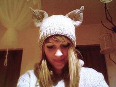 a woman wearing a knitted hat with cat ears