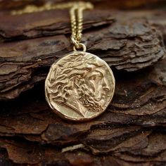 a close up of a coin on a wooden surface with a chain attached to it