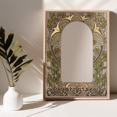 a mirror sitting on top of a table next to a potted plant