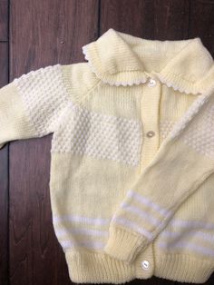 Sweet pale yellow knit cardigan Perfect for spring or Easter celebrations Measurements: sleeve length 12.5 in or 32.5 cm Approximately - 2T Sweet Long Sleeve Cardigan For Spring, Sweet Long Sleeve Spring Cardigan, Cute Yellow Long Sleeve Sweater, Cute Fitted Cream Sweater, Fitted Cream Cute Sweater, Cute Cream Knitted Sweater, Yellow Knitted Cardigan For Spring, Hand Knitted Cream Cardigan For Spring, Spring Yellow Knitted Cardigan