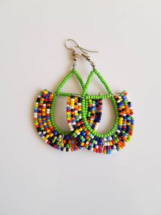 This listing is for ALL 9 pairs. The earrings are 100% handmade using original fine beads. Colorful and bright colors. ^^These earrings ships through dhl express. Buy multiple items and pay shipping for ONE item ONLY. Traditional Multicolor Beaded Hoop Earrings, Traditional Multicolor Beaded Earrings, Traditional Beaded Dangle Hoop Earrings, Multicolor Handmade Beaded Earrings, Traditional Multicolor Earrings With Large Beads, Handmade Multicolor Round Beads Earrings, Colorful Teardrop Jewelry, Traditional Green Teardrop Beaded Earrings, Colorful Traditional Earrings