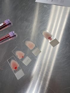 three blood samples are placed on a metal surface