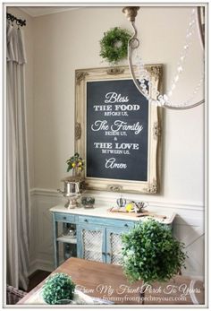 a chalkboard is hanging on the wall next to a buffet table with silverware