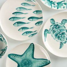 plates with sea animals painted on them are arranged in a pattern and placed next to each other