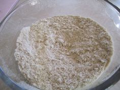 a glass bowl filled with flour on top of a table