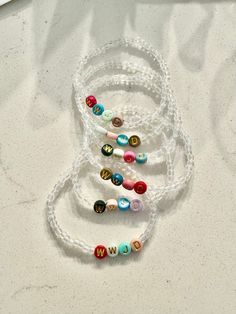 WWJD Stretchy Bead Bracelet is colorful and a beautiful reminder when you look at your wrist.  Made with plastic resin alphabet letter beads, colors chosen at random, and clear beads.  Choose size at checkout.  Be sure not to overstretch. Clear Beaded Bracelets As A Gift, Clear Beaded Bracelets For Gift, White Round Charm Bracelet With Letter Beads, White Letter Beads Charm Bracelet, Clear Beaded Stretch Bracelet As Gift, Adjustable Clear Stretch Bracelet As A Gift, Clear Beaded Bracelets For Gifts, Clear Beaded Bracelet For Gift, White Rosary Bracelet With Round Beads For Friendship