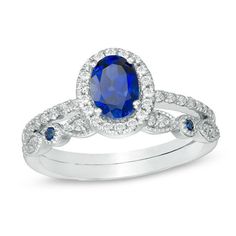 an oval blue sapphire and diamond ring set in 18k white gold with matching band