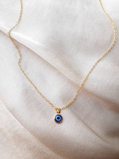 24K gold plated handmade necklace with a small blue evil eye pendant (For the baby blue evil eye necklace in the picture, check out this listing: https://www.etsy.com/uk/listing/1043552572/24k-gold-plated-small-baby-blue-evil-eye?ref=shop_home_active_2&frs=1) Chain length:17 inches (~42.5cm) Chain length may be shortened FREE of charge, please add the length you would like in the personalisation box below upon ordering or message me! Everything comes beautifully wrapped, with a small jewellery p Adjustable Blue Necklace For Her, Adjustable Blue Necklace As A Gift For Her, Handmade Dangle Charm Necklaces In 14k Gold Filled, Handmade 14k Gold Filled Dangle Charm Necklaces, Dainty Blue Necklace For Her, Everyday Blue Tarnish-resistant Jewelry, Handmade Gold Plated Charm Necklace For Everyday, Everyday Yellow Gold Evil Eye Charm Necklaces, Everyday Handmade Gold Plated Charm Necklaces