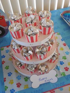 a three tiered cake with silver foil wrapped in tinfoil and dog tags on it