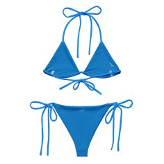 Stay comfortable and beach ready all summer in this FYC String Bikini set. It’s made from soft recycled polyester with double-layering and UPF 50+. Style the straps how you like, and get ready to swim! • Soft and stretchy material with UPF 50+ • Sizes up to 4XL • Bikini top comes with removable padding for comfort • Multiple ways to tie and style the bikini set Disclaimer: To make your All-Over Print Recycled String Bikini last longer, thoroughly rinse it off after each use and get rid of any ch Adjustable Blue Nylon Swimwear, Seamless Nylon Swimwear For Water Sports, Adjustable Nylon Swimwear For Poolside, Adjustable Straps Beachwear Swimwear, Adjustable Nylon Swimwear For Sunbathing, Blue Nylon T-back Swimwear, Adjustable Nylon Swimwear For Beach Season, Sporty Swimwear With Adjustable Straps And 4-way Stretch, Blue Seamless Swimwear With 4-way Stretch