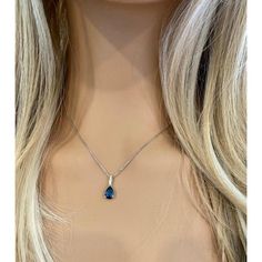 Fourteen karats white gold sapphire and diamond necklace pendant Trending style of layers on layers of gold chains to chunky, retro pendants paired with dainty chokers, layering your necklaces has become an art Necklace measuring 16 inches long Diamond bail hanging pendant 0.35" long with pear shaped sapphire drop Pear Shaped blue sapphire weighing 1.15 carats Sapphire is of royal blue hue Diamond bail weighing 0.10 carats Oval cable chain necklace with spring lock New Necklace Handmade in the USA Some gemstones are very hard to match. The gems that exude subtle color variations are very tough candidates due to color zoning, clarity, and measurements. Our collections challenge our teams in both creativity and know-how.  From the initial drawings through to stone setting and the final polis Diamond Necklace Pendant, Purple Pendant Necklace, Art Deco Pendant Necklace, Black Pendant Necklace, Blue Pendant Necklace, Ruby Necklace Pendant, Sapphire Necklace Pendants, Dainty Choker, White Gold Necklace