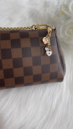 a brown and black purse sitting on top of a white furnishce covered floor