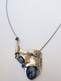 "From Porans collection ----> Unique Silver Pendant, Necklace Kyanite, and Lapis. Description length:55mm width:40mm weight:17.5g The length of the chain is usually 18\"- 22\",  yet can be made at any size you wish, if you are interested in a specific length, Please! write a note on check out Available with many other stones. An amazing gift for yourself or loved ones!  Comes in a beautiful jewelry gift box.  We can also add a personal note in case you would like us to send it as a gift to a lov Unique Polished Pendant Necklace, Formal Silver Pendant Custom Necklace, Artisan Silver Necklace With Unique Design, Handmade Luxury Metal Necklaces, Unique Metal Necklaces With Polished Finish, Handmade Sterling Silver Elegant Necklace, Handmade Formal Necklace With Rectangular Pendant, Handmade Rectangular Pendant Necklace For Formal Occasions, Formal Handmade Necklace With Rectangular Pendant