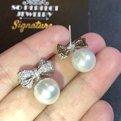 We are presenting you A PAIR OF matching SOUTH SEA PEARLS with LUSTROUS WHITE color. SET IN HANDCRAFTED, 18K SOLID GOLD DROP EARRINGS. ACCENTED WITH 64 E/VS, SPARKLING ROUND BRILLIANT DIAMONDS! IN CASE OF RETURN FOR US BUYERS. BUYERS MAY SEND THE ITEMS BACK TO OUR US-BASED OFFICE IN SALT LAKE CITY, UTAH ONLY ONE ITEM AVAILABLE!! NO DUPLICATES!! WHAT YOU SEE IN THE PICTURES IS WHAT YOU WILL GET SOLIDLY HANDCRAFTED EARRINGS! SUGGESTED RETAIL VALUE: $9,880 PEARLS: Size: 12 mm Shape: Oval/Round Colo Cubic Zirconia Round Pearl Earrings For Party, Classic White Pearl Earrings For Party, White Cubic Zirconia Party Earrings, Diamond White Elegant Bridal Earrings For Party, Elegant Pearl White Pearl Earrings For Party, White Cubic Zirconia Evening Earrings, Evening White Cubic Zirconia Earrings, Exquisite Diamond White Bridal Earrings For Party, Elegant Pearl White Earrings For Party