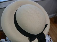 Really great 1940's Panama hat. It is a nice creamy beige with a pale yellow hue. Not white. It has a round crown with a deep u at the bottom between crown and brim. The brim is turned down all around. I do not know if this is the supposed shape but this was kept in a hat box since it was bought. I would like the front brim to be flat and turned down like a fedora. Not sure it that could be done I personally not attempt it although I have seen UTube videos on this. The hat looks good as is on fo Classic Cream Hats With Short Brim, Classic Cream Brimmed Hats, Classic Beige Brimmed Top Hat, Classic Cream Fitted Top Hat, Classic Cream Brimmed Boater Hat, Classic Cream Sun Hat With Short Brim, Classic Cream Panama Hat For Kentucky Derby, Classic Adjustable Cream Boater Hat, Classic Cream Panama Hat With Wide Brim