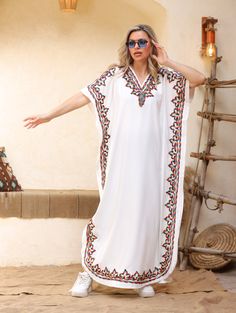 An elegant and stylish caftan will make you feel like African royalty. It's extremely elegant with a dash of colorful cotton embroidery adorning the kaftan. Ideal for plus size women as well. Made of extremely soft fabric to make you feel free and beautiful at the same time.  This Kaftan is ideal to wear for any casual occasion. Whether taking a trip down the shopping lane, or home-based kitty parties, or about anything else, wearing this dress will make you feel classy and comfortable. Fabric : Bohemian Tunic Abaya For Vacation, Bohemian Abaya With Kimono Sleeves For Vacation, Embroidered Kaftan For Beach, Traditional Tunic Abaya For Beach, Summer V-neck Embroidered Abaya, White Maxi Dress For Eid Vacation, Summer Embroidered V-neck Abaya, Beach Abaya Free Size, Embroidered Free Size Kaftan For Vacation