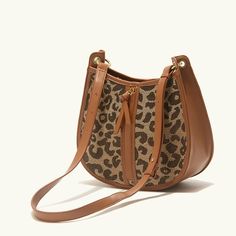 Upgrade Your Style with the Leopard Saddle Shoulder Bag Elevate your fashion game with our Leopard Saddle Shoulder Bag, crafted from premium microfiber leather for a luxurious feel. Designed for the modern woman, this bag combines functionality with trend-setting style, making it the perfect accessory for any occasion. Product Features Microfiber leather upper for durability and a sleek look Polyester lining material for added strength and resilience Zipper closure for secure storage of your essentials Bow decoration adds a touch of charm and femininity Spacious interior with an interior slot pocket for easy organization Available in classic Black or versatile Brown Benefits You'll Love Elevated Style: Stand out from the crowd with the chic leopard print design and sleek saddle shape of th Sleek Look, The Chic, Saddle, Modern Woman, Classic Black, Fashion Games, Daily Wear, Womens Watches, Leopard Print