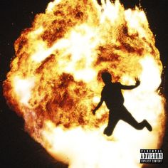 a man is silhouetted in front of a large fireball that appears to be exploding