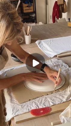 a woman is working on an art project