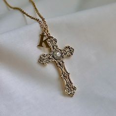 The Gold Cross Necklace for women features a custom letter charm, making it an ideal personalized jewelry gift for her. This religious jewelry includes a gold cross pendant with an initial charm for a unique touch. The perfect religious gift for couples, friendships, or family! 𝐃𝐄𝐓𝐀𝐈𝐋𝐒:  ⭐️ Necklace lengths available: 14" 16" 18" 20" ⭐️ Pendant size is 2" ⭐️ The gold cross pendant is long lasting gold plated over metal. The chain necklace & Letter charm is made up of high quality stainles Cross Necklace Women, Letter Charm Necklace, Gold Cross Necklace, Gold Cross Pendant, Custom Letters, Gold Cross, Letter Charms, Religious Jewelry, Religious Gifts